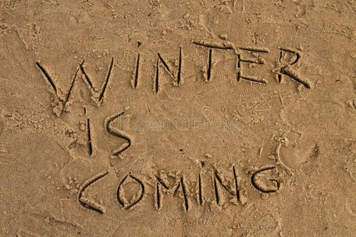 winter-coming-sign-beach-wet-sand-78731805